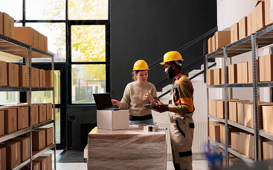 Modern warehouse with workers scanning barcodes
