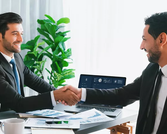 Client and consultant reviewing a project on a laptop