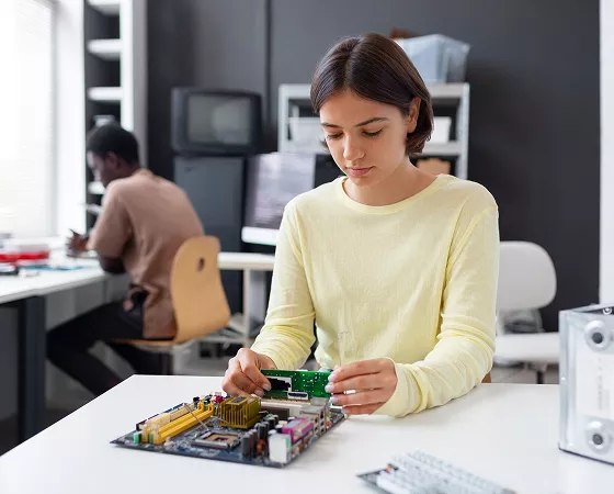 A modern electronics manufacturing facility with robotic arms assembling circuit boards.