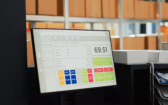 Warehouse worker scanning a package with inventory data on a screen